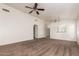 Spacious living room with neutral carpet and ceiling fan, showcasing a clean and open layout at 1608 S 82Nd Dr, Phoenix, AZ 85043