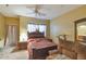 Cozy main bedroom with a ceiling fan, ensuite bathroom, plush bedding, and comfortable furnishings at 1718 W Colter St # 126, Phoenix, AZ 85015