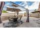 Inviting backyard patio with a dining set under a canopy, perfect for outdoor entertaining at 1733 N 77Th Dr, Phoenix, AZ 85035