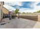 Spacious backyard patio with a canopy-covered dining set, ideal for relaxation and entertaining at 1733 N 77Th Dr, Phoenix, AZ 85035