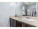 Bathroom vanity with dark cabinets and large mirror at 1733 N 77Th Dr, Phoenix, AZ 85035