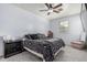 Bright primary bedroom featuring a ceiling fan, carpet and neutral decor at 1733 N 77Th Dr, Phoenix, AZ 85035
