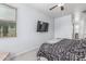 Bright bedroom with ceiling fan, mounted television and neutral decor at 1733 N 77Th Dr, Phoenix, AZ 85035