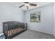 Cozy bedroom featuring a crib and natural light from a window at 1733 N 77Th Dr, Phoenix, AZ 85035