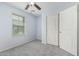Bedroom features a ceiling fan, carpet and closet at 1733 N 77Th Dr, Phoenix, AZ 85035