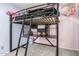 A bedroom featuring a loft bed with a study area underneath at 1733 N 77Th Dr, Phoenix, AZ 85035
