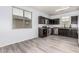 Well-lit kitchen with stainless steel appliances, wooden cabinets and laminate flooring at 1733 N 77Th Dr, Phoenix, AZ 85035