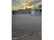 Large backyard with gravel landscaping and block fencing, perfect for low-maintenance outdoor living at 1813 E Boise St, Mesa, AZ 85203
