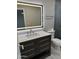Modern bathroom with vanity with quartz countertop, LED mirror, and stainless steel fixtures at 1813 E Boise St, Mesa, AZ 85203