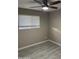 Bedroom featuring wood-look flooring, a window and ceiling fan at 1813 E Boise St, Mesa, AZ 85203