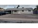 Well-maintained single-story home with freshly painted gray brick and manicured landscaping at 1813 E Boise St, Mesa, AZ 85203