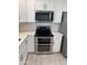 Close-up of modern stainless steel double oven, microwave, and white cabinetry at 1813 E Boise St, Mesa, AZ 85203