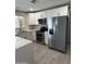 Well-lit kitchen featuring stainless steel appliances and white cabinetry with modern hardware at 1813 E Boise St, Mesa, AZ 85203
