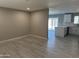 Open-concept space with wood-look floors, seamlessly connecting the living area to the kitchen at 1813 E Boise St, Mesa, AZ 85203