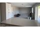 Bright, open-concept living room with white cabinets and durable wood-look flooring at 1813 E Boise St, Mesa, AZ 85203