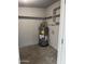 Utility room featuring a newer water heater and minimalist shelving, providing practical home amenities at 1813 E Boise St, Mesa, AZ 85203