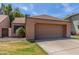 Exterior view of the home featuring a large two-car garage and a well-manicured lawn at 1836 N Stapley Dr # 191, Mesa, AZ 85203