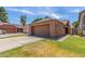 Exterior view of the home featuring a large two-car garage and a well-manicured lawn at 1836 N Stapley Dr # 191, Mesa, AZ 85203