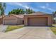 Exterior view of the home featuring a large two-car garage and a well-manicured lawn at 1836 N Stapley Dr # 191, Mesa, AZ 85203