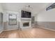 Living room showcasing wood floors and a cozy fireplace with a mounted television at 1836 N Stapley Dr # 191, Mesa, AZ 85203