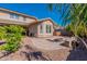 A backyard with a fire pit, hot tub and a covered patio on a sunny day at 20557 W Lost Creek Dr, Buckeye, AZ 85396
