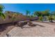 A backyard features a fire pit with seating and a manicured landscape at 20557 W Lost Creek Dr, Buckeye, AZ 85396