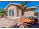 Hot tub adjacent to the house with a paver patio and rock landscaping at 20557 W Lost Creek Dr, Buckeye, AZ 85396