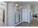 Bright bathroom with a glass enclosed shower, and a doorway to the exercise room at 20557 W Lost Creek Dr, Buckeye, AZ 85396