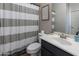 Bathroom featuring a vanity with chrome fixtures, toilet, and shower with a striped curtain at 20557 W Lost Creek Dr, Buckeye, AZ 85396