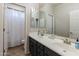 Well-lit bathroom with double sinks, ample counter space, and a shower, providing comfort and functionality at 20557 W Lost Creek Dr, Buckeye, AZ 85396