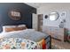 Stylish bedroom with dark accent wall, a comfortable bed, and modern decor, creating a cozy and inviting space at 20557 W Lost Creek Dr, Buckeye, AZ 85396