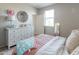 Bright bedroom with dresser, round mirror, and light-colored walls creates a cozy atmosphere at 20557 W Lost Creek Dr, Buckeye, AZ 85396