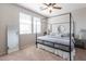 Bright bedroom featuring a canopy bed, neutral walls, and a ceiling fan creating a serene and relaxing retreat at 20557 W Lost Creek Dr, Buckeye, AZ 85396