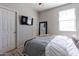 Inviting bedroom with a tv, a comfortable bed, neutral walls, and a ceiling fan creating a relaxing space at 20557 W Lost Creek Dr, Buckeye, AZ 85396