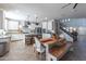 Spacious open layout with a kitchen island, wooden dining table, and stairs leading to the upper level at 20557 W Lost Creek Dr, Buckeye, AZ 85396