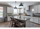 Bright kitchen with a large island, granite countertops, stainless steel appliances, and modern pendant lighting at 20557 W Lost Creek Dr, Buckeye, AZ 85396