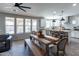 Open layout features a wooden dining table with a kitchen island and modern stainless steel appliances at 20557 W Lost Creek Dr, Buckeye, AZ 85396