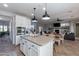 Bright, open kitchen featuring an island with seating, granite countertops, and modern stainless steel appliances at 20557 W Lost Creek Dr, Buckeye, AZ 85396