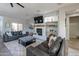 Cozy living room featuring a fireplace, built-in shelves, and comfortable leather couches at 20557 W Lost Creek Dr, Buckeye, AZ 85396