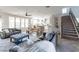 Open-concept living area with a view of the staircase and a dining space adjacent to the kitchen at 20557 W Lost Creek Dr, Buckeye, AZ 85396