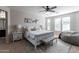 Well-lit main bedroom featuring a bench seat, a bed, and plenty of natural light at 20557 W Lost Creek Dr, Buckeye, AZ 85396