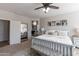 Bright and airy main bedroom featuring a bed, dresser and view of the ensuite bathroom at 20557 W Lost Creek Dr, Buckeye, AZ 85396