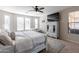 Well-lit main bedroom featuring a bed, dresser, TV and windows for ample natural light at 20557 W Lost Creek Dr, Buckeye, AZ 85396