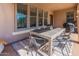 Covered patio featuring a dining table and chairs with multiple windows allowing light at 20557 W Lost Creek Dr, Buckeye, AZ 85396