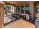 Covered patio featuring an outdoor dining table, chairs, and stone pillars at 20557 W Lost Creek Dr, Buckeye, AZ 85396