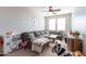 Inviting playroom with a comfortable gray couch, playful decor, and a ceiling fan, perfect for Gathering fun at 20557 W Lost Creek Dr, Buckeye, AZ 85396