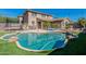 Sparkling swimming pool, artificial turf and desert landscaping in a backyard setting at 20557 W Lost Creek Dr, Buckeye, AZ 85396