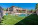 Beautiful backyard pool and home featuring artificial turf, patio and desert landscaping at 20557 W Lost Creek Dr, Buckeye, AZ 85396