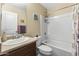 Bright bathroom with a single sink vanity, and a shower-tub combination at 2111 N 77Th Gln, Phoenix, AZ 85035