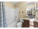 Bathroom with a shower-tub combination, vanity sink, and neutral-toned decor at 2111 N 77Th Gln, Phoenix, AZ 85035